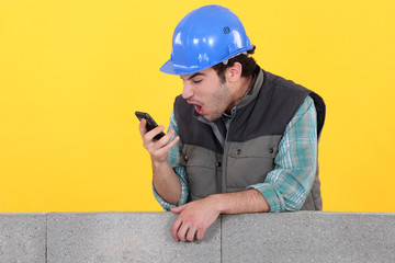 Man staring at his mobile phone in disbelief