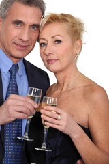 Mature couple toasting with champagne.