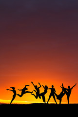 Fototapeta na wymiar silhouette of friends dancing in sunset