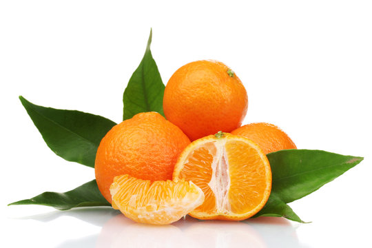 Ripe tasty tangerines with leaves and segments isolated on