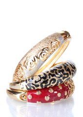 Beautiful golden bracelets isolated on white