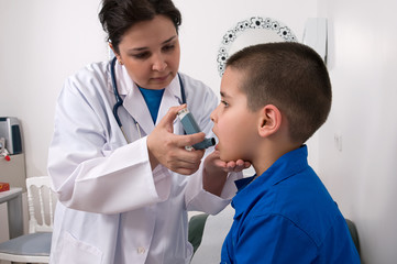 Medical doctor applying oxygen treatment on a little boy