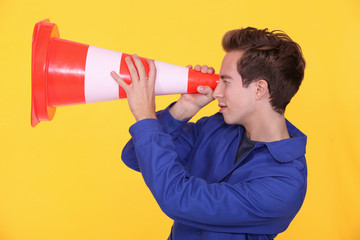 Worker with a traffic cone
