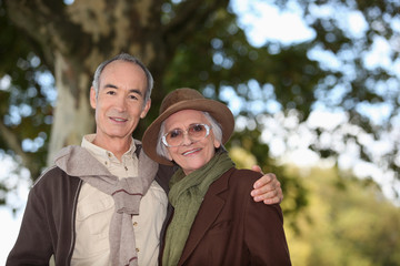 Fototapeta premium Elderly couple taking a walk together in the forest