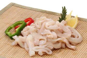 Pile of raw squid rings over white