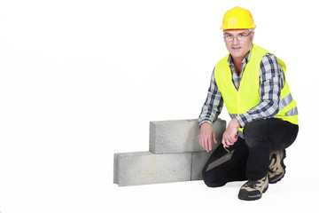 A kneeled mature mason.