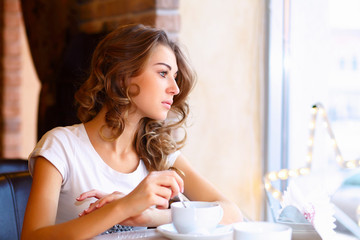 Young pretty woman sitting in restaurant