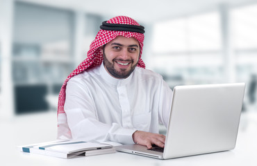 arabian businessman using laptop in his office