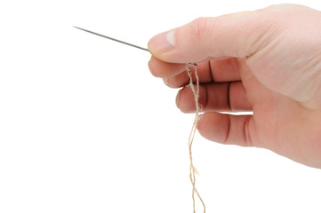 Needle and thread in hand closeup
