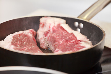 beef steak in a frying pan
