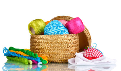 bright threads for needlework and fabric in a wicker basket