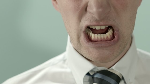 Close-up of angry businessman screaming. Copy space