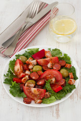salad with meat and olives on the plate