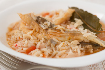 rice with fish on the white plate