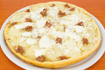 pizza with potatoes and sausage in pieces