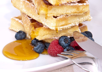 Fresh waffles with fruits and sirup