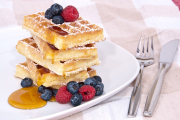 Fresh waffles with fruits and sirup