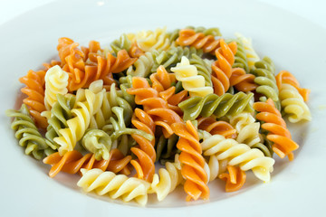 Spiral tricolor pasta on plate