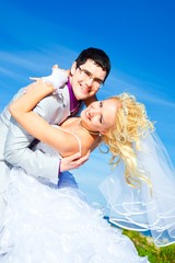 happy groom and bride on a sea coast