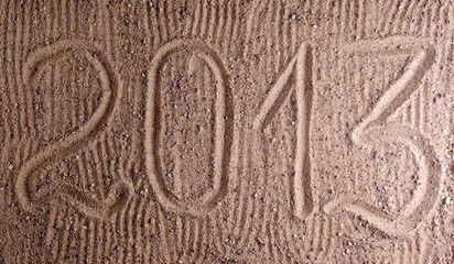 inscription 2013 on sand