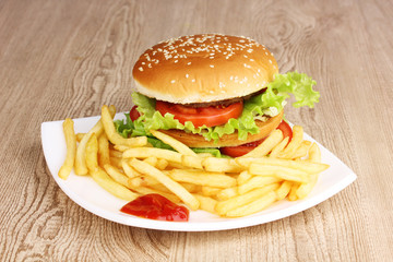 Big and tasty hamburger and fried potatoes