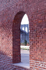 Brooklyn Bridge framed through brick window