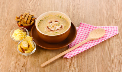Tasty soup on wooden background