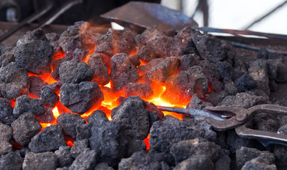 Forge with hot flaring coal