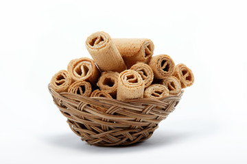 Crispy cinnamon rolls in a basket on a white background.