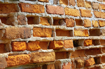 Old front wall with weather-beaten bricks