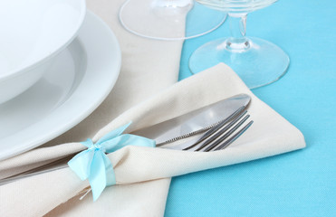 Table setting with fork, knife, plates, and napkin