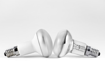 Energy saving and filament light bulbs on gray background