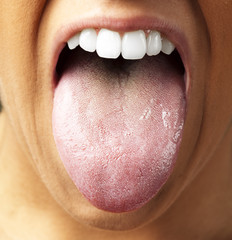 woman showing the tongue, closeup