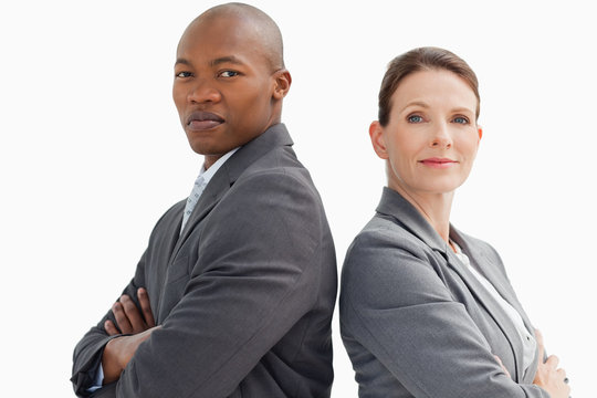 business people with hands crossed looking at camera
