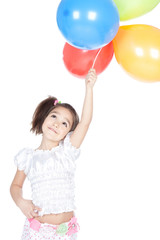 Fototapeta na wymiar Little brunette girl with balloons in studio