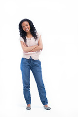 A young woman standing with her arms folded is smiling