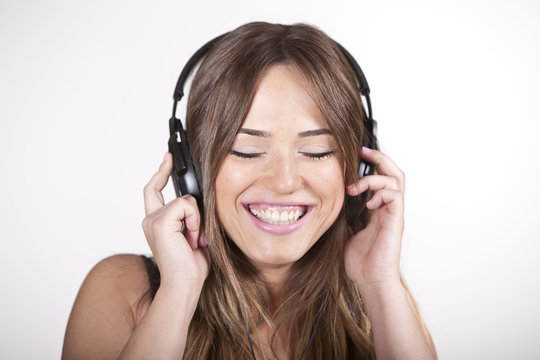 Beautiful cheerful young woman enjoying music