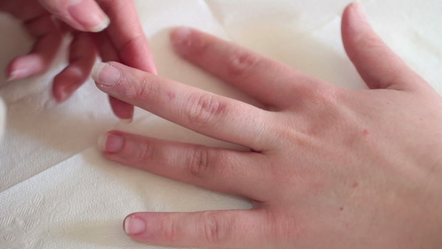 Beautician polishing nails