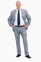 Portrait of a man in a suit with hands on hips