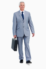 Portrait of a businessman with a suitcase walking