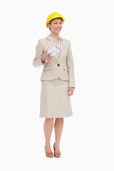 Woman in a suit wearing a safety helmet