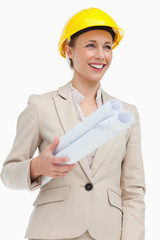 Smiling woman in a suit wearing a safety helmet