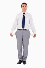 Upset man showing his empty pockets