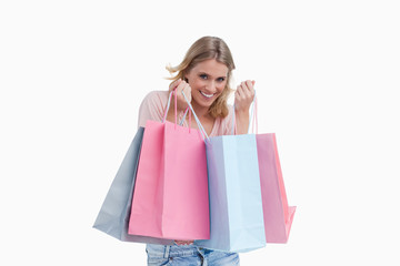 Fototapeta premium A smiling woman is carrying shopping bags