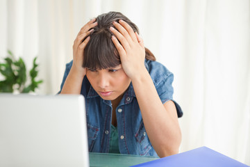 Depressed student looking at her computer