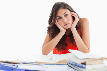 Portrait of a bored student doing her homework
