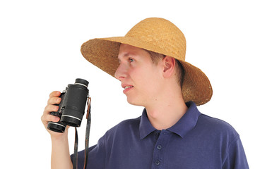 Young man with binoculars and straw hat