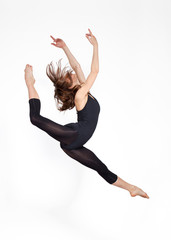 young beautiful ballerina on a gray background