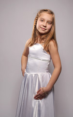 Smiling girl blonde in a white dress