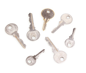 Many metal keys isolated on white